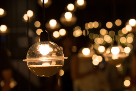Lamps and LED light bulb with with bokeh effect in blackgroundの写真素材