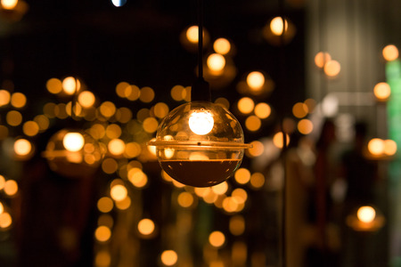 Lamps and LED light bulb with with bokeh effect in blackgroundの写真素材