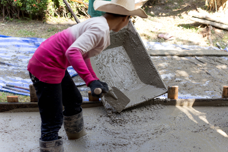 Woman construction worker during concreting floors in construction siteの写真素材