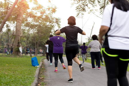 Group of people doing exercise aerobics dancing in the parksの写真素材