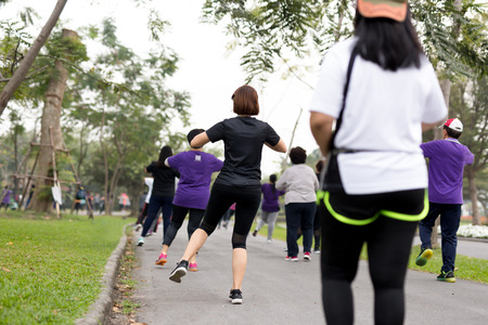 Group of people doing exercise aerobics dancing in the parksの写真素材