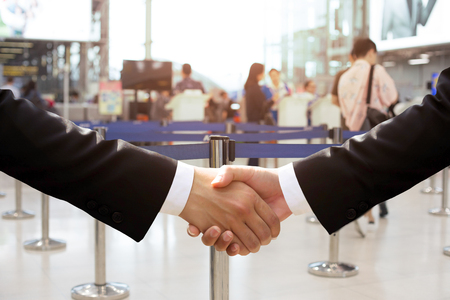 Business trip conceptual business hand shake in airport buildingの写真素材
