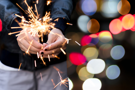 Yiung girl holding a sparkle with bokeh light in backgroundの写真素材