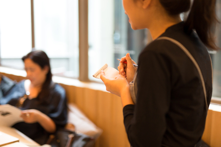 Selected focus on pen waitress taking order at restaurant sofrt focusの写真素材