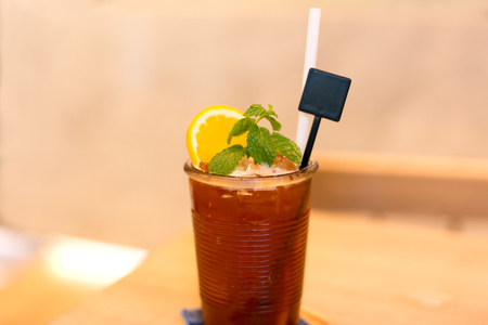 Iced tea with lemon and mint on the table in blur backgroundの写真素材