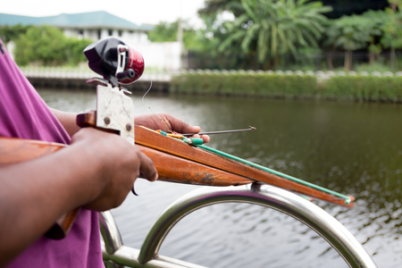 Man preparing speargun for Spearfishing on the riverの写真素材