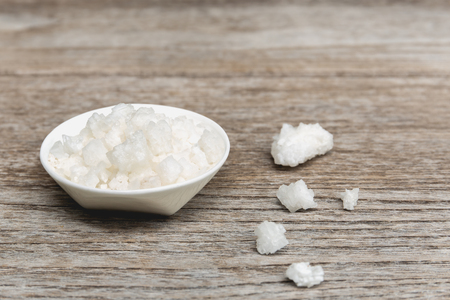 Bowl of sea salt on wooden backgroundの写真素材