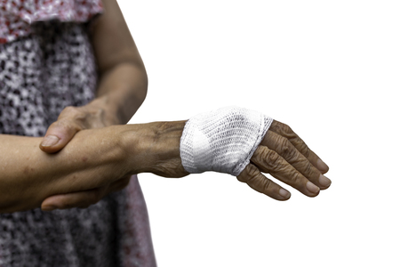 Senior woman hand injury with bandage isolated in clipping pathの写真素材