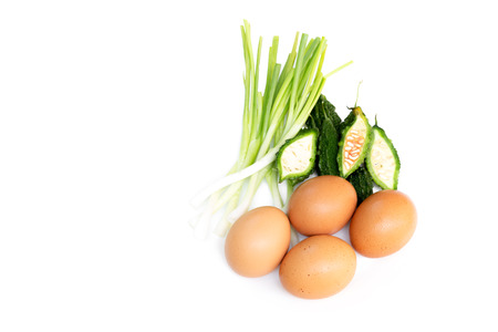 Bitter gourd , eggs and spring onion solated on white backgroundの写真素材