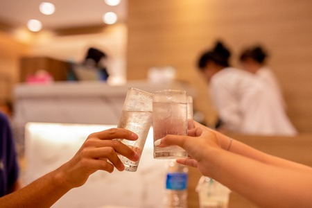 Happy family and friends having dinner party clinking drink.の写真素材