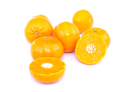 Whole oranges and slices of orange isolated on white backgroundの写真素材