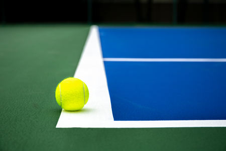 Tennis ball on a blue tennis court outdoor.の写真素材