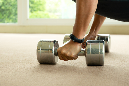 Attractive sport man working out with dumbbells in gym.の写真素材