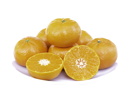 Whole oranges and slices of orange in white plate isolated on white background in clipping path.の写真素材