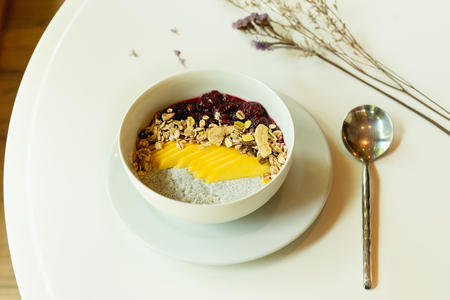 Healthy breakfast of smoothie bowl with chia pudding and fruit on the tableの写真素材
