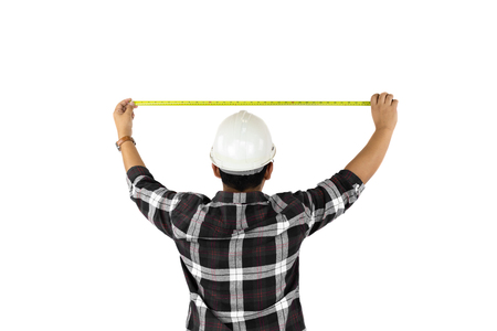 Builder measuring size with tape meter isolated on white backgroun.の写真素材