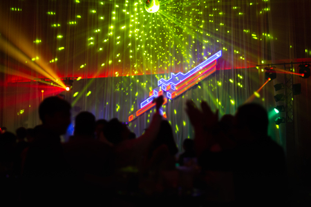 Blurred concept at concert party with audience and colourful led lighting.の写真素材