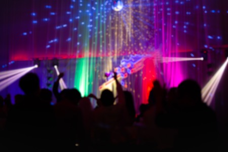 Blurred concept at concert party with audience and colourful led lighting.の写真素材