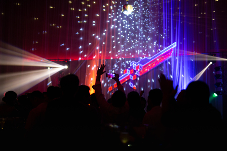 Blurred concept at concert party with audience and colourful led lighting.の写真素材