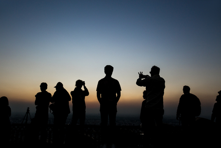 Silhouettes group of people taking pictures at sunset in Nahagarh Fort Jaipur.の写真素材