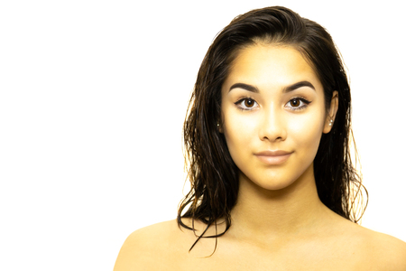 Mixed race young woman face isolated on whiteの写真素材