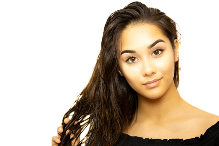 Mixed race young woman face portrait isolated on whiteの写真素材