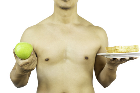 Man holding green apple and slice of bread in clipping path.の写真素材