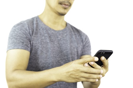 Sportman holds cell phone isolated in clipping path.