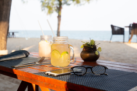 Lemon and honey drink with slice of lime on table refreshing summer drink.