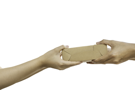 Hand giving package parcel isolated in clipping path.