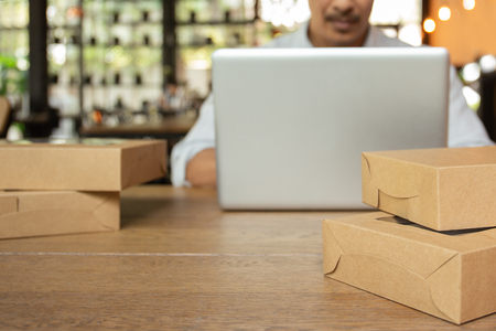 Startup business man working on computer laptop with parcel on table.の写真素材