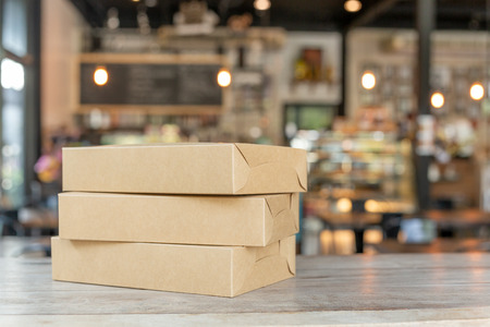 Brown parcel package box for gifts on the table.の写真素材
