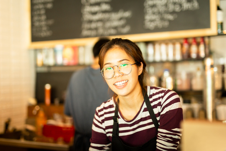 Asian woman amiling work in small business owner food and drink cafe.の写真素材
