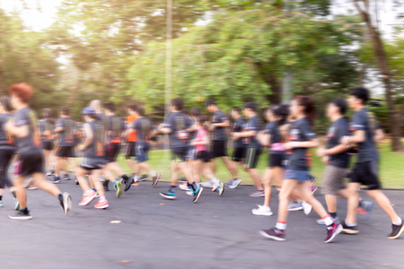 Blurred group of marathon people jogging in the park in morning.の写真素材