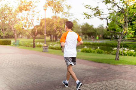 Unidentified middle aged man jogging in the park in morning.の写真素材