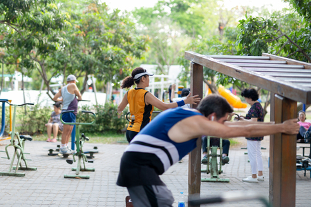 Unidentified group of people exercising weight training in the park.の写真素材