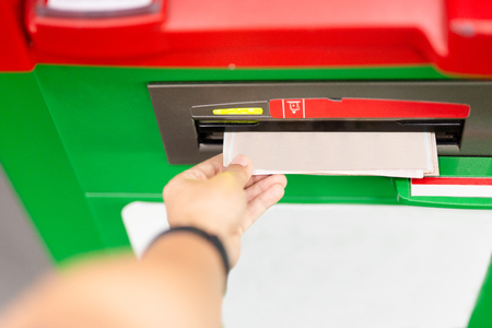 Hand of man using an ATM machine with credit card.の写真素材
