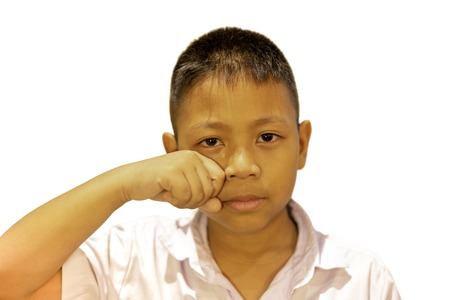 Portrait of asian boy crying with his hand cover his face in clippinh path.の写真素材