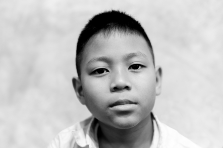 Portrait of asian boy crying with tear on his face in black and white.の写真素材