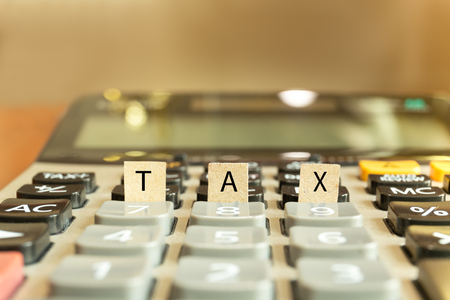 Calculator with the word tax written in paper conceptual.の写真素材