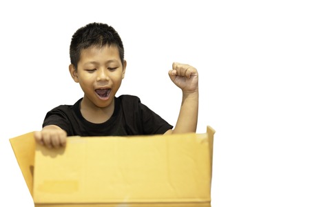 Boy surprised by opening parcel box isolated in clipping path.の写真素材