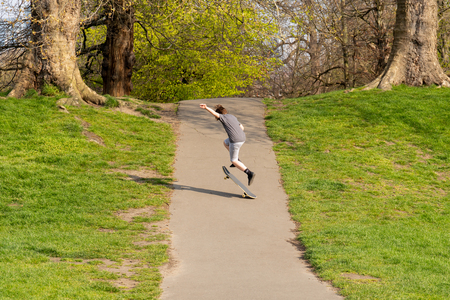 Young boy playing Skateboard in the park in summer.の写真素材