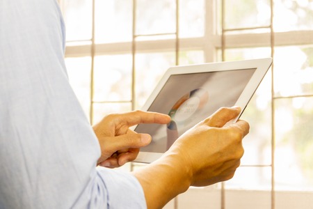 Business man working on the Tablet with 2020 goals stock market chart.の写真素材