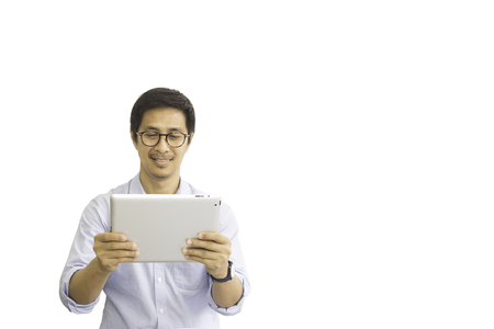 Asian man with eyeglasses looking at tablet isolated clipping path.の写真素材