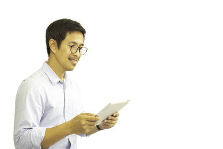 Asian man with eyeglasses looking at tablet isolated in clipping path.の写真素材