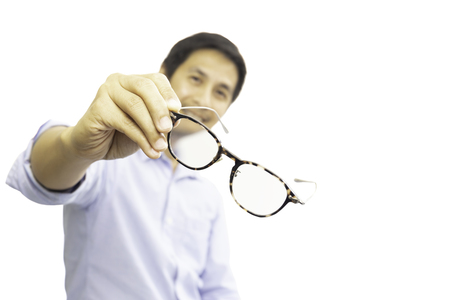Man holding eyeglasses for a try out isolated in clipping path.の写真素材