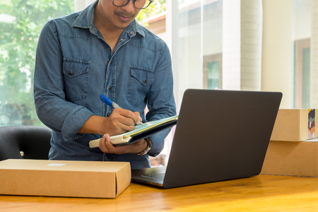 SME business owners checking inventory with laptop on the table.の写真素材