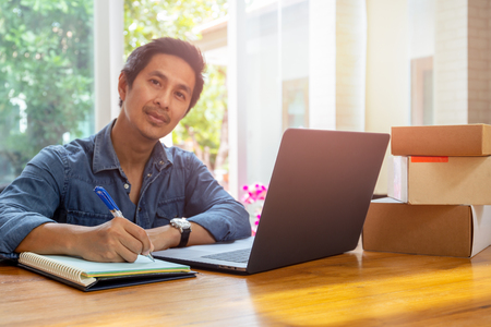 SME business owners checking inventory with laptop on the table.の写真素材