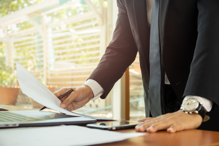 Businessman working at his office with documents paperwork.の写真素材