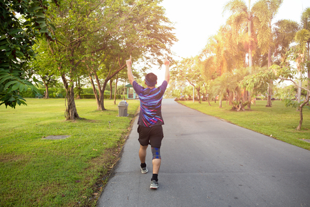 Unidendified man winner celebrating sport success raising hands up.の写真素材